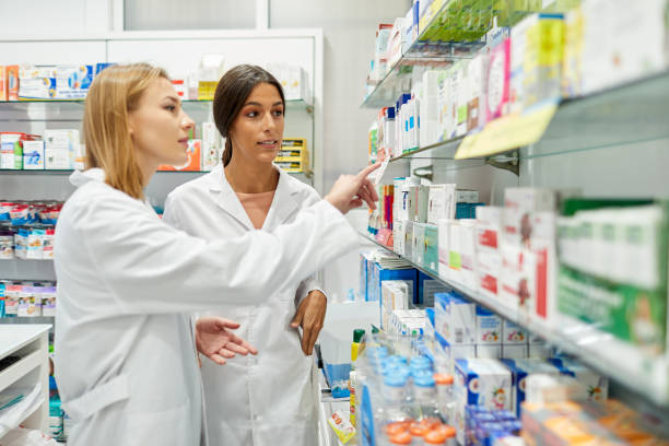 istock Two pharmacist sorting medicines in the shelves. 1219519165