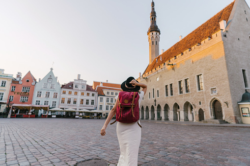 Young Caucasian woman walking in Tallinn in the morning