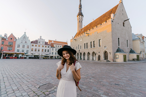 Young Caucasian woman walking in Tallinn in the morning