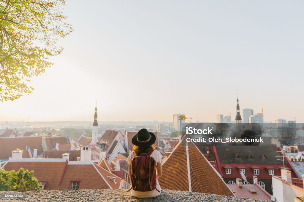 Woman sitting and looking at Tallinn in the morning Young Caucasian woman sitting and looking at Tallinn in the morning Tallinn Stock Photo