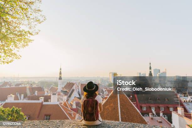 Woman Sitting And Looking At Tallinn In The Morning Stock Photo - Download Image Now