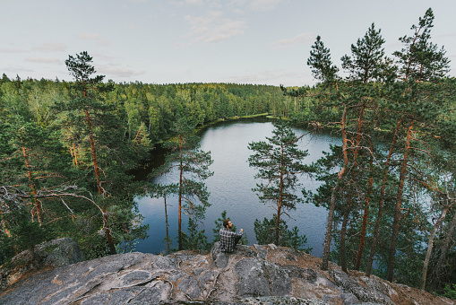 Young Caucasian man walking near the lake in summer