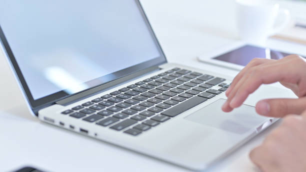 istock Close Up of Hands making Report on Laptop 1219525673