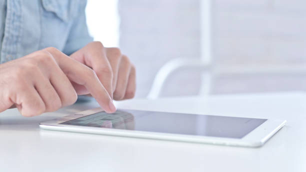 istock Close Up of Young Guy Hands using Tablet 1219525686