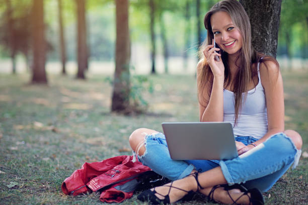 istock Young girl is talking in the park 1219525689