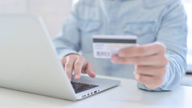 istock Online shopping, Using Credit Card on Laptop 1219525701