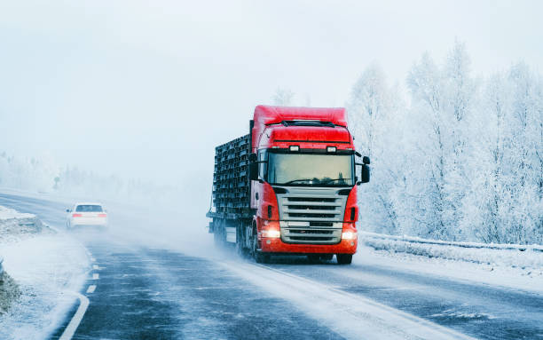 camion sulla strada invernale innevata della lapponia finlandese - covered truck foto e immagini stock