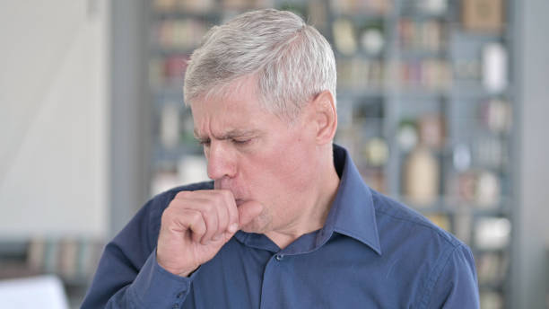 istock Portrait of Middle Aged Man feeling Sick and Coughing 1219526430