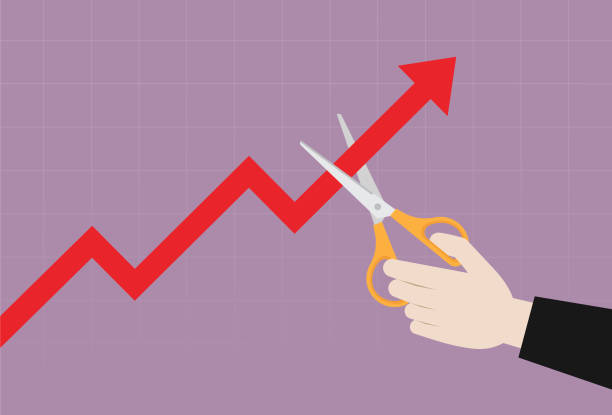 istock Businessman uses scissors to cut a stock market graph 1219529880