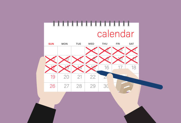 istock Businessman draws a cross mark on a calendar 1219529908