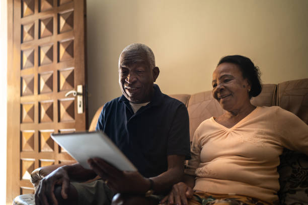 istock Senior couple on a video calling using a digital tablet at home 1219530410