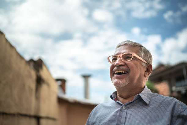 istock Senior man looking up dreaming at home 1219530699
