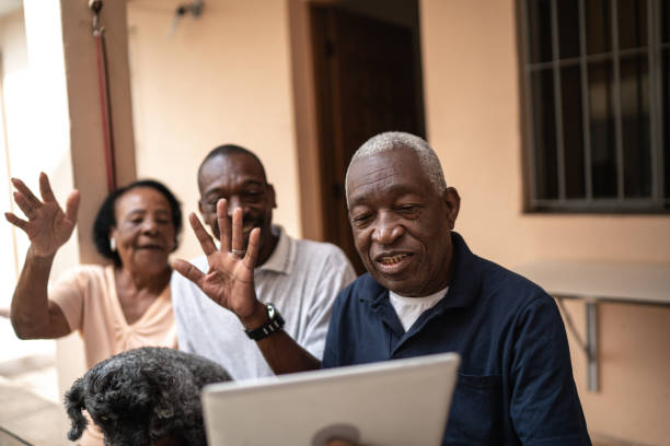 istock Family on a video calling using digital tablet at home 1219530715