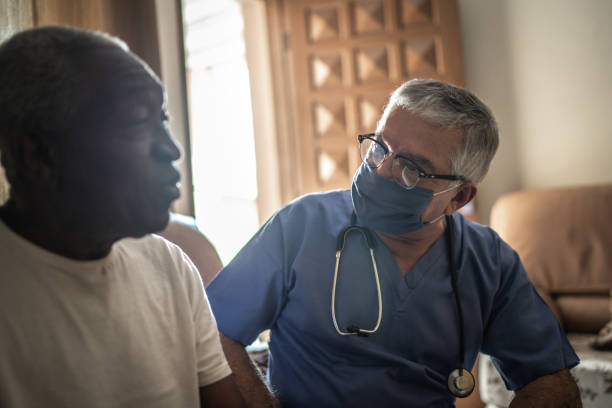 istock Health visitor and a senior man during home visit 1219530806