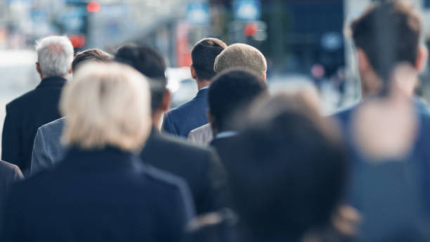 istock Diverse and Multicultural Office Managers and Business People Commute to Work or from Office on Foot. Pedestrians are Dressed Smartly and Walk Away. Successful People Walking in Downtown. 1219532680