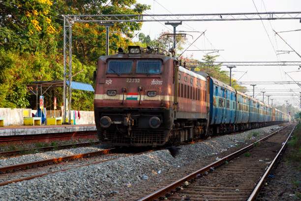 Kochi, Kerala, India -January 21, 2020 a train moving with electric support through the track in Indian railway Kochi, Kerala, India -January 21, 2020 a train moving with electric support through the track in Indian railway india train stock pictures, royalty-free photos & images