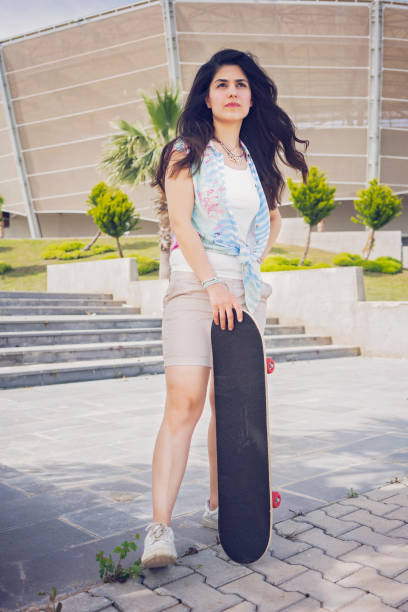 istock Young woman with skateboard. 1219533598