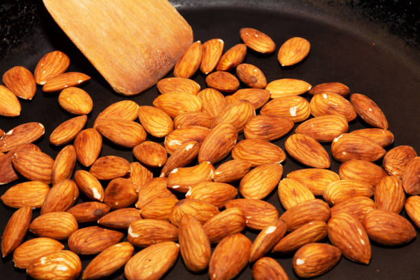 istock Process of frying almonds in a pan 1219533791