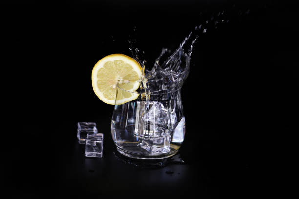 istock ice water splash with lemon slice isolated on black background 1219536471