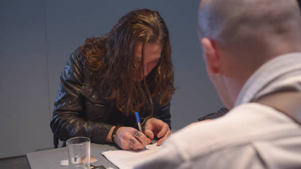 istock The criminal for fear signs the documents 1219540449