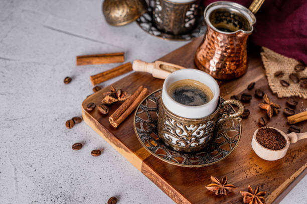 istock Coffee cup, beans and scoop with ground powder on a modern white background 1219542487