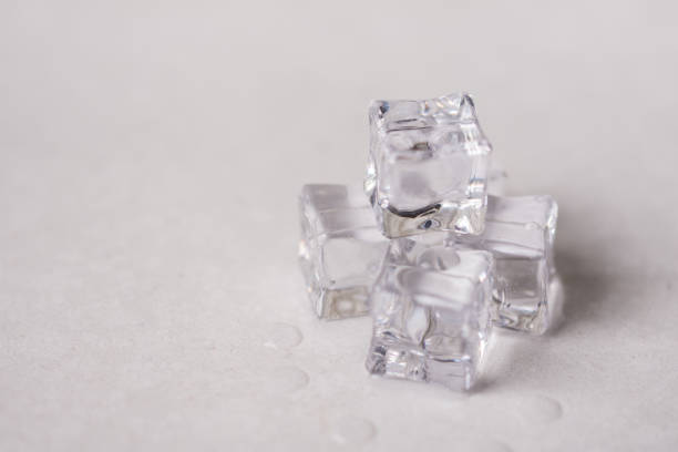 istock Ice cubes with water drops on the white marble background 1219544817