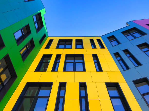 istock Multi-colored facades of the school with black window frames. 1219545291