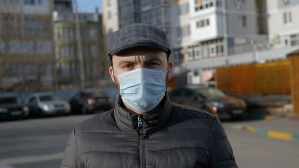 istock Bearded man with medical mask looking at camera 1219545299