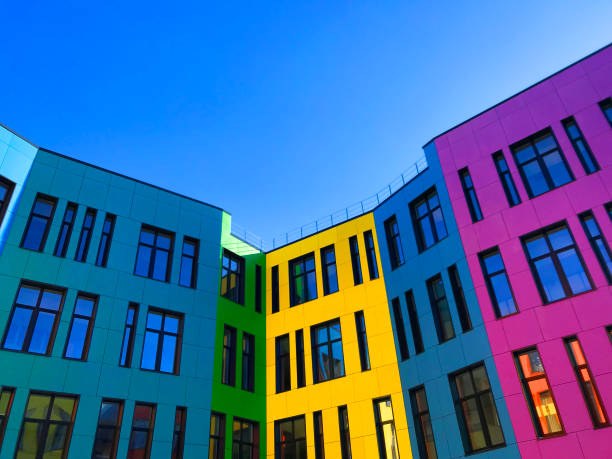 istock Multi-colored facades of the school with black window frames. 1219545304