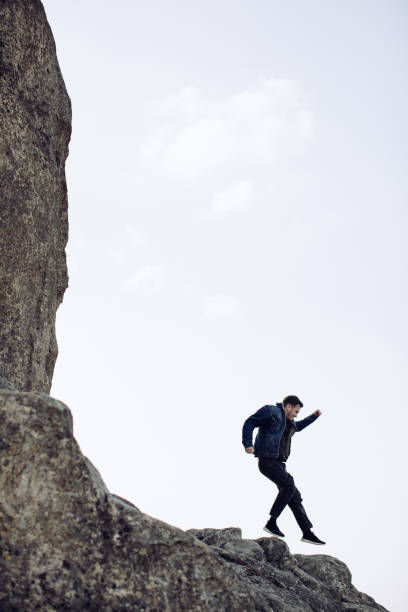istock A young man is jumping on a rock 1219547526
