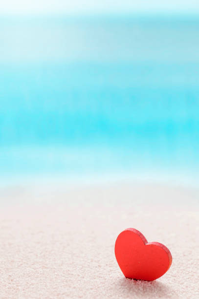 istock Red heart on sandy sea beach, love summer and relaxation concept. 1219547607