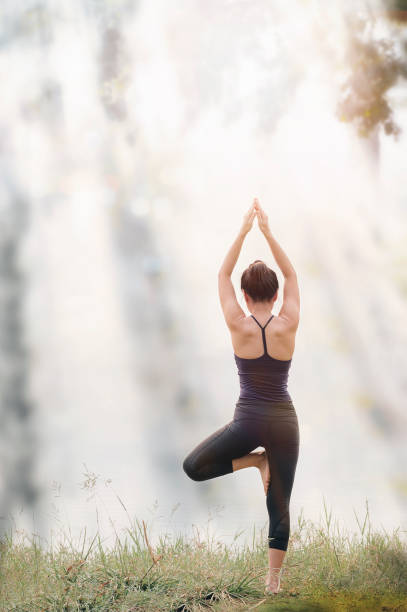 istock Young woman is practicing yoga under the sunlight. 1219547764