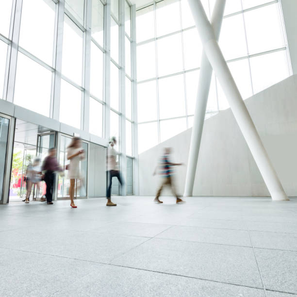istock Group of people walking in modern building lobby 1219548660