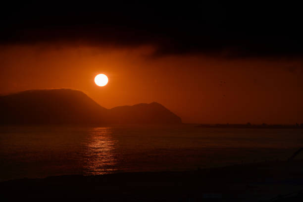 bright sunset over the sea beach with gazebos