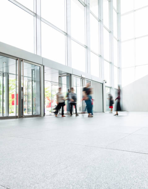 istock Group of people walking in modern building lobby 1219548821
