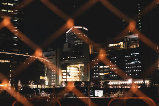 istock Building light at night through the fence 1219550272