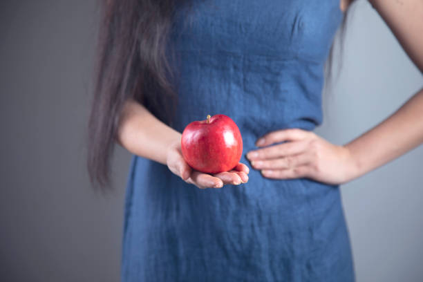 istock happy woman hand holding apple and diet 1219551111