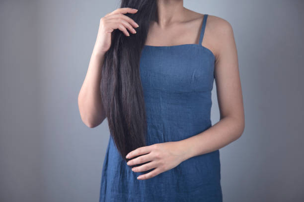 istock woman touching in long hair 1219551157