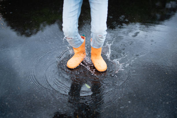 istock Feet of a child playing in a puddle 1219552250