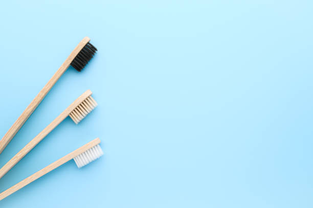 Zero waste concept. Set of eco friendly bamboo toothbrushes on a light blue background. stock photo
