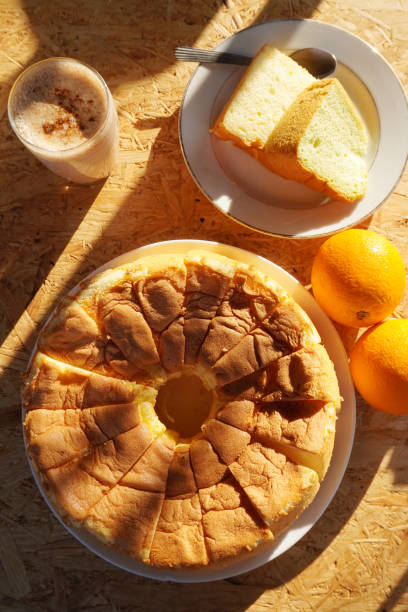 istock Fresh orange cake and chai latte on wooden table during morning time. 1219553467