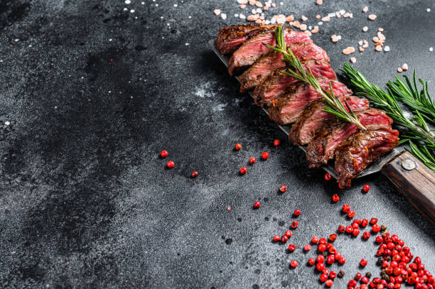 istock Grilled skirt, machete steak. Marble meat beef. Black background. Top view. Copy space 1219554968