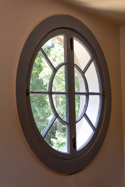 istock Large circular window in an old residential building seen from inside 1219556855