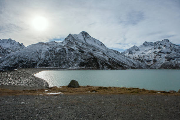 hügel mit bergsee, der ruhe ausdrückt, mit einem schotterparkplatz im vordergrund - silvretta stock-fotos und bilder