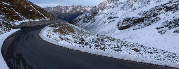 panorama of a winding road with snowy landscape in the ötztal in austria panorama of a winding road with snowy landscape in the ötztal in austria rettenbach glacier stock pictures, royalty-free photos & images
