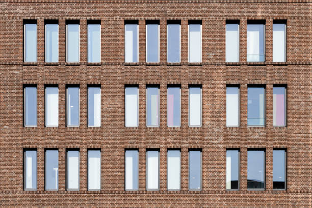 Dutch clinker brick facade in different brown and red tones with high and narrow window