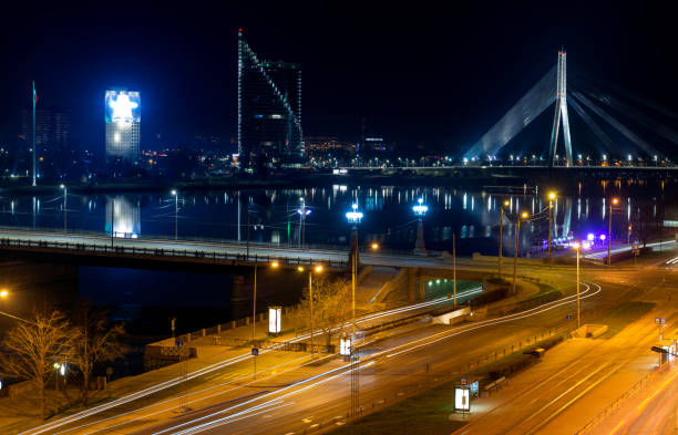 istock Modern bridge and buildings in Riga at night 1219558274