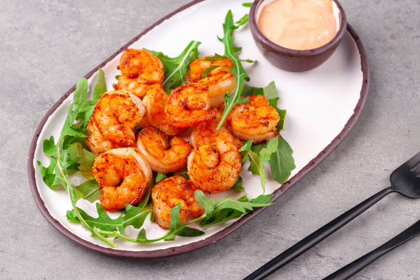 istock Hot appetizer fried king shrimps, arugula, sauce 1219558370