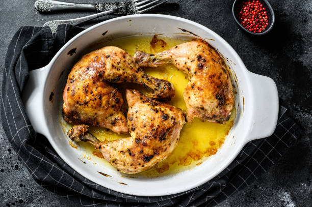 istock Fried chicken thighs, legs with spices. Black background. Top view 1219558431
