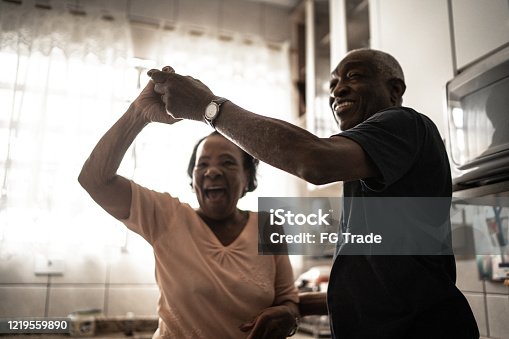 istock Senior couple dancing at kitchen 1219559890